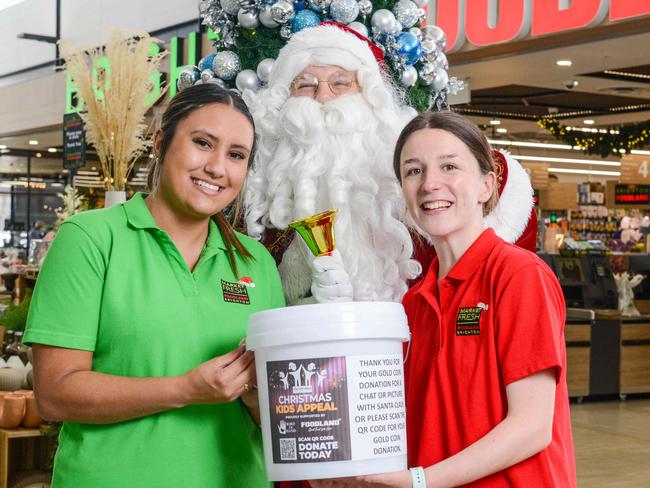 Father Christmas helps kick off The Advertiser Foundation Kids Christmas Appeal with customer service assistants Katie Abbott and Abbie Mitchell at Brighton Foodland, DECEMBER 5, 2022: Picture: Brenton Edwards