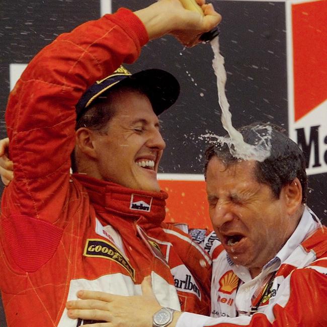 Michael Schumacher douses Jean Todt in Champagne after winning the Hungarian Grand Prix