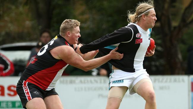 Daniel Archer tackles Hillside’s Jaksyn Grant. Picture: Hamish Blair