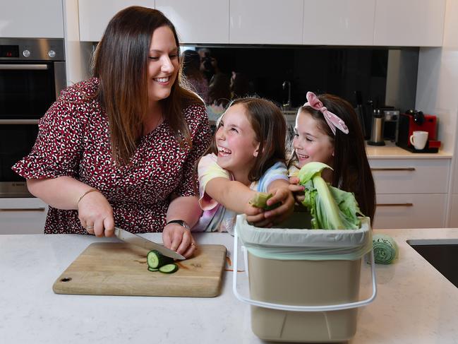 Alicia Sandercock with her daughters Summer 6 and Ruby 8 use the Kitchen Caddy to dispose of their kitchen green waste at their Warradale home Monday September 28,2020.Picture Mark Brake