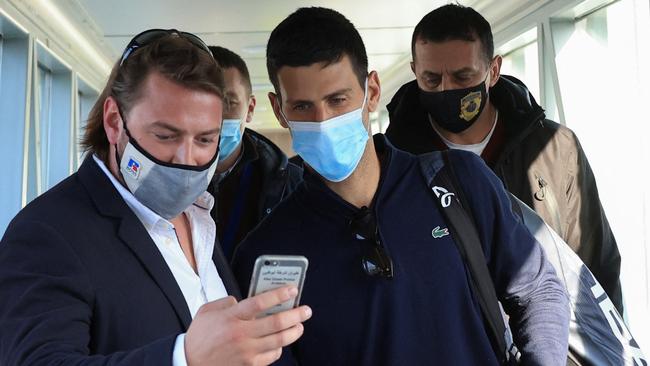 A man takes a selfie with Novak Djokovic as he arrives at Nikola Tesla Airport. Picture: Reuters.