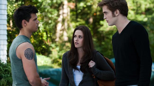 Taylor Lautner as Jacob Black, Kristen Stewart as Bella Swan and Robert Pattinson as Edward Cullen.