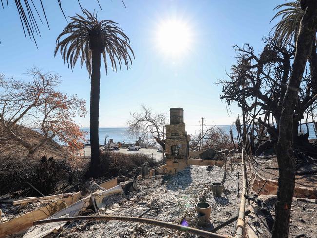 A chimney stands amid burnt trees and ashes in a destroyed property overlooking the Pacific Ocean after the Palisades fire, in Malibu, California. Picture: AFP