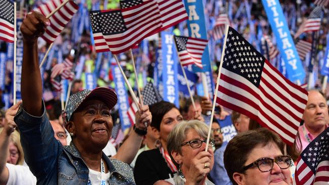 Delegates wave flags at the Democratic National Convention as Hillary Clinton becomes the first woman to be a Presidential candidate for the United States. (Pic: AFP/Robyn Beck)