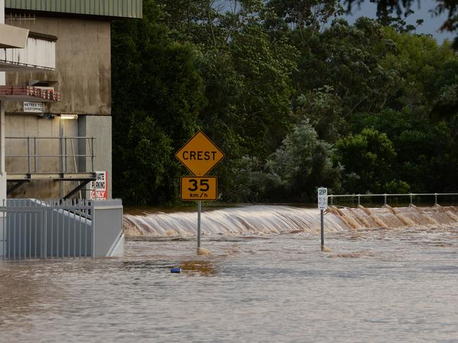 Floodwater gong over the levee wall in Molesworth Street, Lismore.