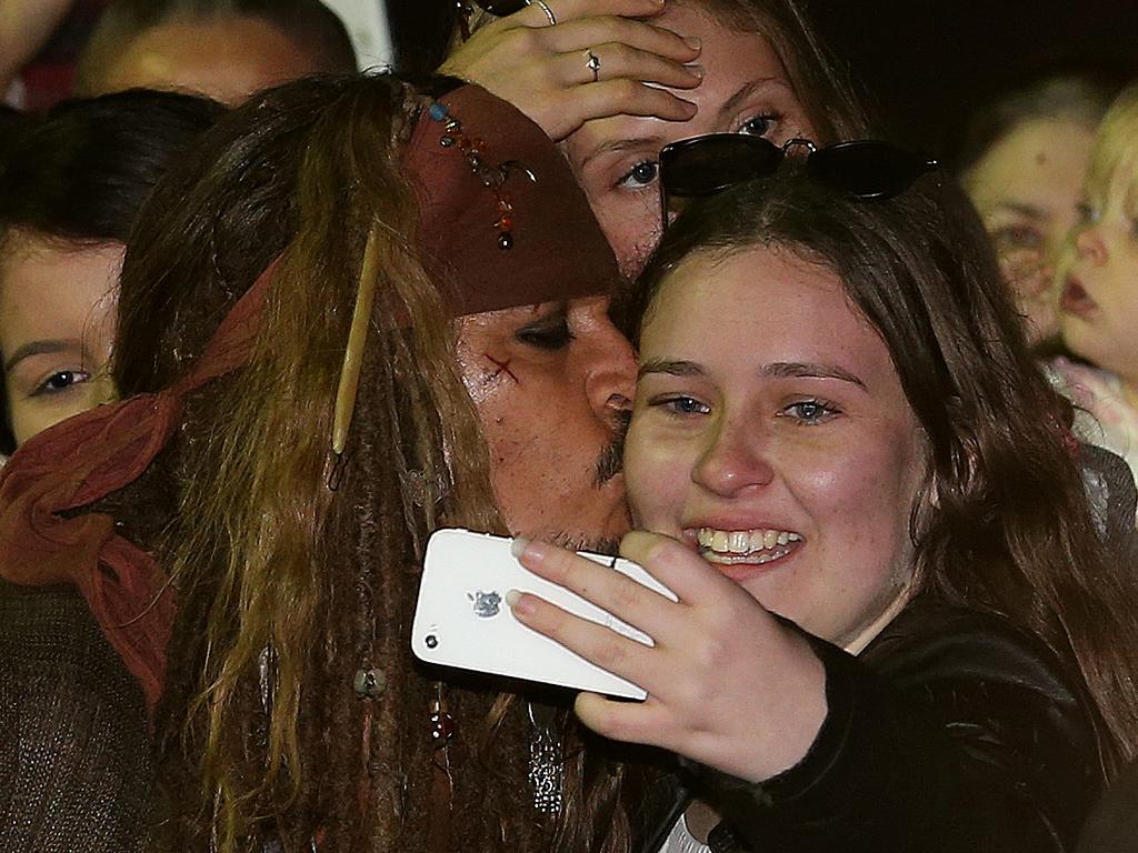 Hollywood actor Johnny Depp kisses a fan who waited several hours to see him at The Spit after filming of the Pirates of the Caribbean, Gold Coast. Picture: Regi Varghese