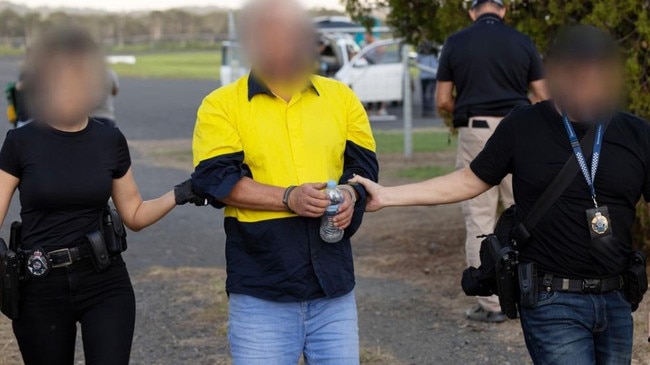 A man is arrested by police. Picture: AFP