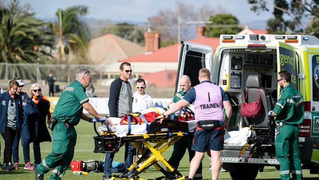 Katelyn Rosenzweig is carried away to an ambulance at Alberton Oval. Picture: AAP / Morgan Sette