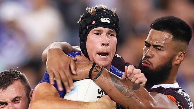 SYDNEY, AUSTRALIA - MARCH 20:  Matt Burton of the Bulldogs is tackled during the round two NRL match between the Canterbury Bulldogs and the Brisbane Broncos at Accor Stadium, on March 20, 2022, in Sydney, Australia. (Photo by Mark Kolbe/Getty Images)