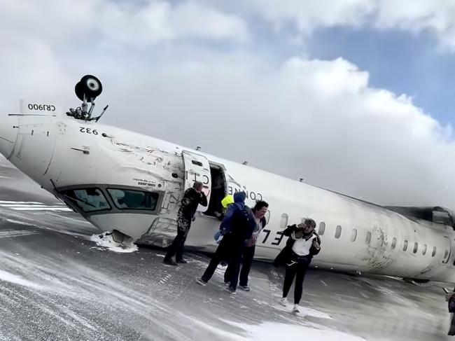 Images shot  by passenger Pete Koukov who was on a Delta Air Lines plane that crashed while landing Monday afternoon at the snowy Toronto Pearson International Airport. Picture: Pete Koukov/@eggxit Instagram