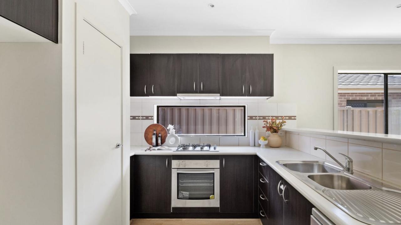 This decade-old property includes a sleek kitchen with ample storage and natural light.