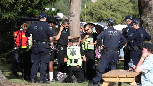 A man being treated by medics at the FOMO music festival in Western Sydney. A 19-year-old woman died in hospital after taking drugs at the festival. Picture: David Swift.