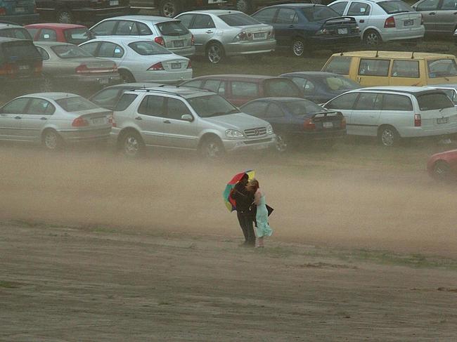 Caught in the middle of the carpark, this couple had nowhere to run when a storm swept through Flemington in 2004.