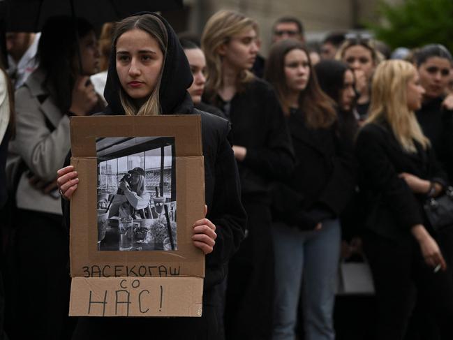 Sofia holds a picture of Nadica, 17, her friend and victim during a memorial ceremony. Picture: AFP