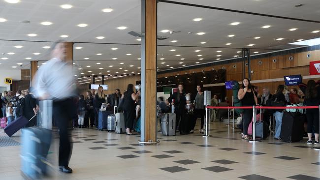 People queuing to check in at Hobart Airport. Picture: LUKE BOWDEN