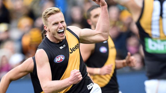 Nathan Drummond of the Tigers (left) reacts after kicking his first AFL goal during the Round 18 AFL match between the Hawthorn Hawks and the Richmond Tigers at the MCG in Melbourne, Sunday, July 24, 2016. (AAP Image/Julian Smith) NO ARCHIVING, EDITORIAL USE ONLY