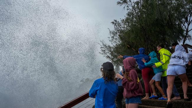 TWEED HEADS, AUSTRALIA - MARCH 06: Onlookers evade a crashing wave on March 06, 2025 in Tweed Heads, Australia. Tropical Cyclone Alfred is expected to make landfall in southeast Queensland and northern NSW as a Category 2 storm, marking the first time a cyclone has directly hit the region in over 50 years. The storm is forecast to bring damaging winds, heavy rainfall, and potential storm surges, prompting authorities to urge residents to prepare for significant impacts, including flooding and power outages. (Photo by Asanka Ratnayake/Getty Images)