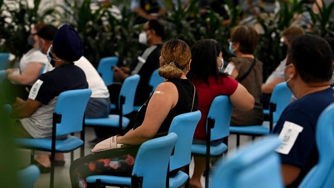 Members of the public wait in the observation area after receiving a COVID-19 vaccination at the South Western Sydney Vaccination Centre on January 5, 2022. Picture: AAP Image/Bianca De Marchi