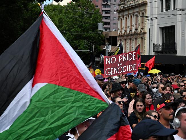 Aboriginal and Palestinian flags were among those waved at the Invasion Day rally in Melbourne Picture: Luis Enrique Ascui