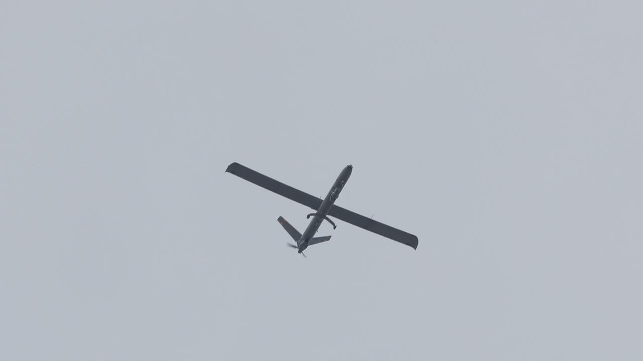 This picture taken from Israel's southern border with the Gaza Strip shows an Israeli unmanned aerial vehicle (UAV or drone) flying over the Palestinian territory on May 15, 2025. (Photo by Jack GUEZ / AFP)