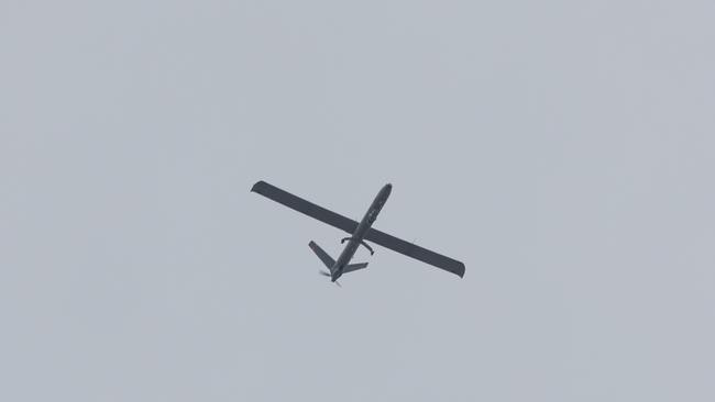 This picture taken from Israel's southern border with the Gaza Strip shows an Israeli unmanned aerial vehicle (UAV or drone) flying over the Palestinian territory on May 15, 2025. (Photo by Jack GUEZ / AFP)