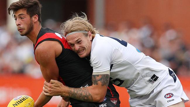 Geelong’s Tom Stewart tackles Essendon’s Kyle Langford. Picture: Getty Images