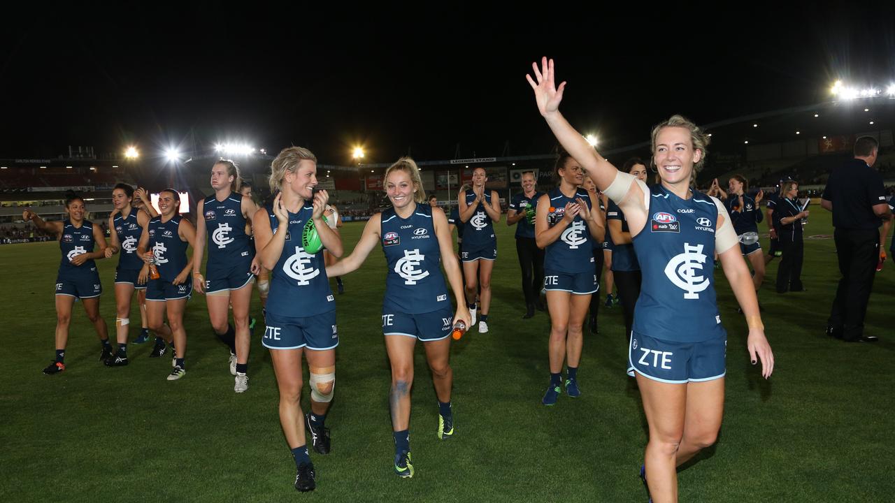 Arnell leads the Blue off after Carlton wins the first AFLW game. Picture: George Salpigtidis