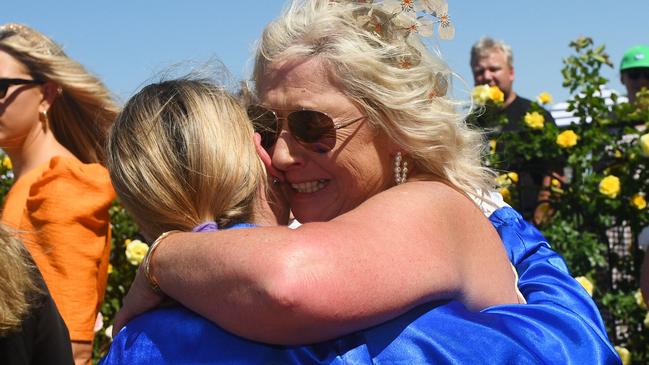 Jamie Kah is hugged by Dean Holland’s mum, Belinda, after winning the Newmarket Handicap on Cylinder.