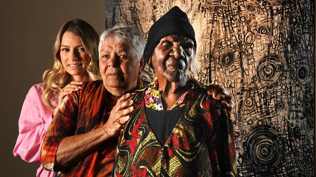Jade Torres, 27, her grandmother Barbara Weir, 80, and great grand-aunt Emily Pwerle, 97, with the Atnwengerrp exhibition from Utopia at Tandanya. Picture: Tricia Watkinson