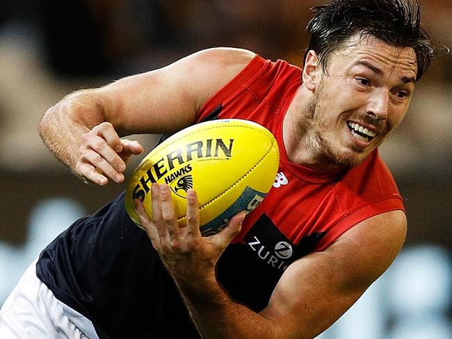 MELBOURNE, AUSTRALIA - APRIL 15:  Michael Hibberd of the Demons handpasses the ball during the round four AFL match between the Hawthorn Hawks and the Melbourne Demons at Melbourne Cricket Ground on April 15, 2018 in Melbourne, Australia.  (Photo by Daniel Pockett/AFL Media/Getty Images)