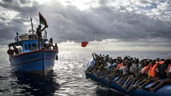 An award-winning photo from 2016 captures a Libyan vessel’s interaction with a boat packed with refugees. Picture: Mathieu Willcocks