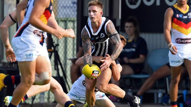 AFL COMEBACK STALLED: Port Adelaide’s Hamish Hartlett breaks a tackle in a SANFL trial against the Crows last month. Picture: Tom Huntley