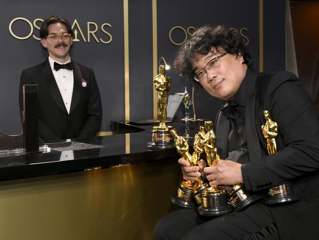 Bong Joon-Ho holds up the line at the trophy engraving desk backstage at the Oscars. Picture: Kevork Djansezian/Getty Images