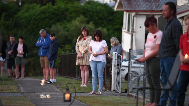 People stand outside their homes at dawn to commemorate Anzac Day in Brisbane, Saturday, April 25, 2019. Anzac Day is a national day of remembrance to commemorate the service and sacrifice of Australian and New Zealand service men and women. Due to COVID-19 restrictions marches and commemorative services have been banned for the first time in more than a century. (AAP Image/Dan Peled) NO ARCHIVING
