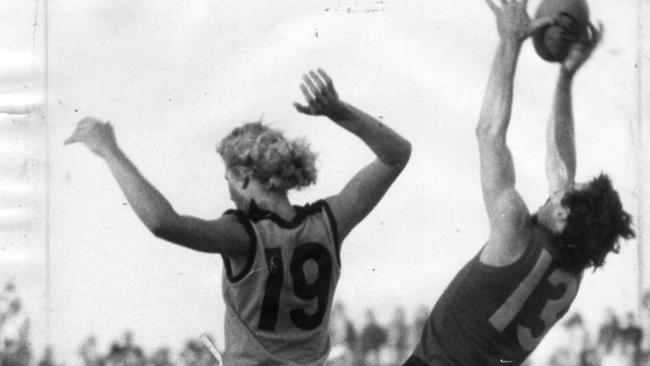 Neil Sachse, pictured in his football days, outmarks Gary Sidebottom during a SA vs. WA interstate match at Football Park in May 1974.