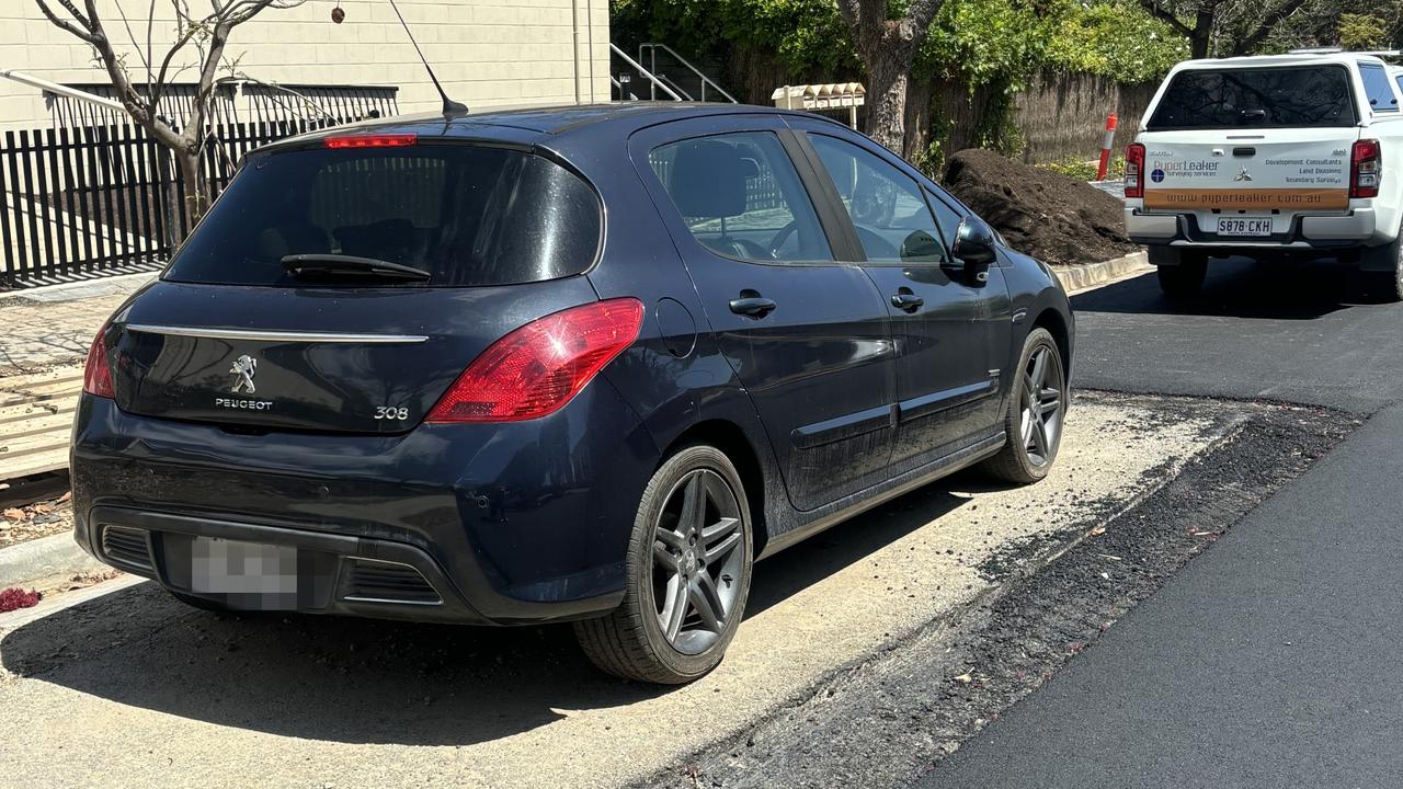 Road workers in Mitcham didn’t let a parked car on the street stop them from completing their job. Picture: Supplied