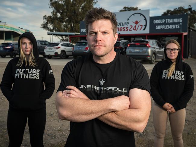 Cobram Victoria, AUSTRALIA - Herald Sun - June 7th, 2020:L-R Paige Lindner, Tayler Hocking and Tamara Blackley.Tayler Hocking (0407070367) runs a Future Fitness 24/7 gym in Cobram. He can only have 10 people exercise outside but no other business. Across the river in NSW, people are free to go to the gym and Victorians are able to cross and use that gym over the border.He's pulling his hair out about the absurdity of the inconsistent rules.BYLINE -  Simon Dallinger