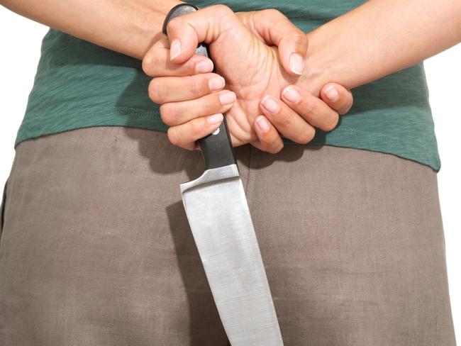 woman detail back with a big knife on her hands