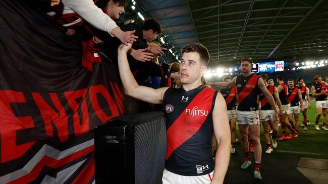 MELBOURNE, AUSTRALIA - AUGUST 12: Zach Merrett of the Bombers celebrates with fans during the 2023 AFL Round 22 match between the North Melbourne Kangaroos and the Essendon Bombers at Marvel Stadium on August 12, 2023 in Melbourne, Australia. (Photo by Michael Willson/AFL Photos via Getty Images)