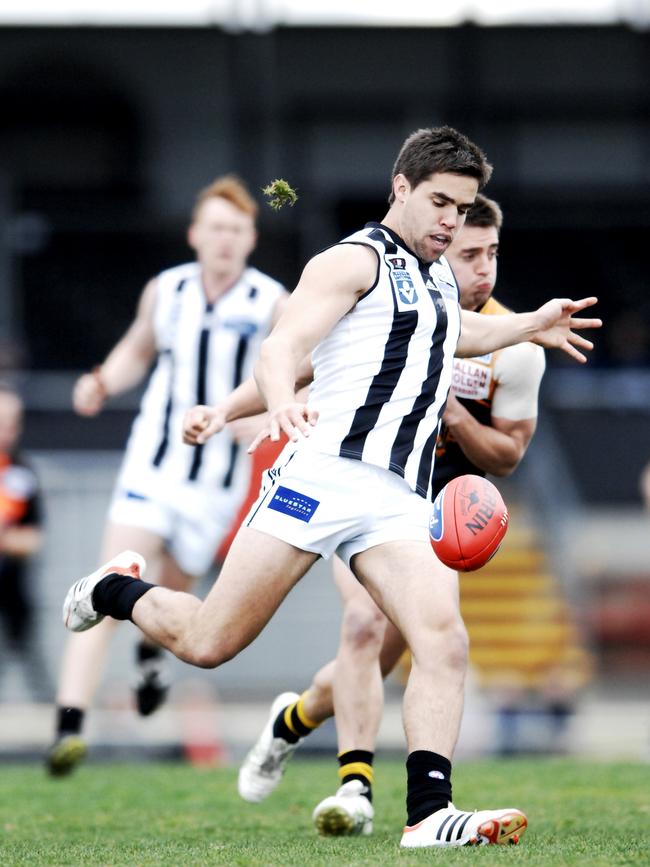 Simon Buckley takes a kick for the Pies. 