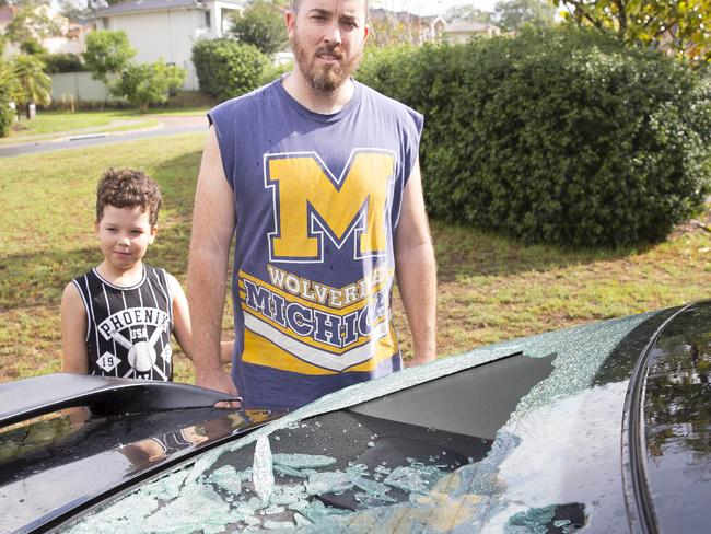 Ben Little and his son Benji check out the damage on their Toyota Camry. Picture: Melyvn Knipe