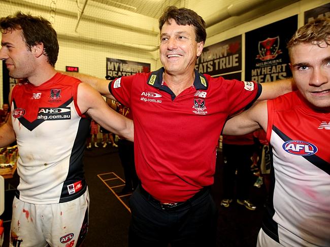 Melbourne coach Paul Roos celebrates the win against Carlton with his players. Picture: Wayne Ludbey. 