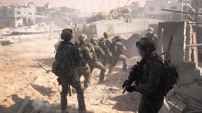 Israeli troops advance with the cover of armour in the northern Gaza Strip on Sunday: Picture: Reuters