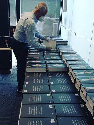 Former Prime Minister Malcolm Turnbull wears a face mask while signing copies of his new book. Picture: Instagram