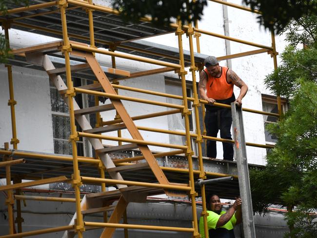 Workers get stuck in on the infamous site yesterday. Picture: Penny Stephens
