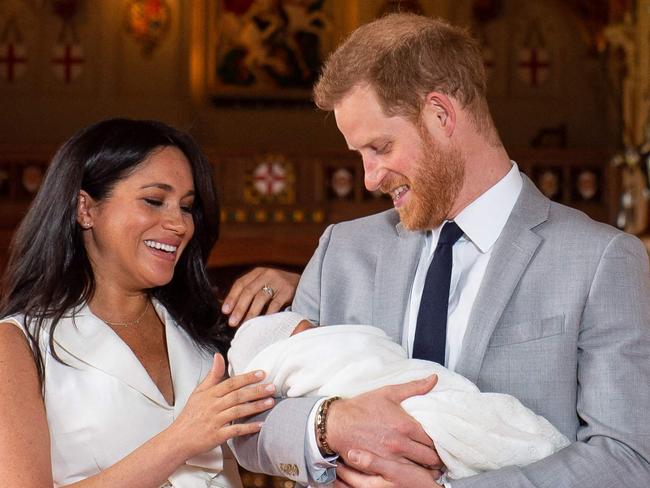 (FILES) In this file photo taken on May 08, 2019 Britain's Prince Harry, Duke of Sussex (R), and his wife Meghan, Duchess of Sussex, pose for a photo with their newborn baby son, Archie Harrison Mountbatten-Windsor, in St George's Hall at Windsor Castle in Windsor. - Scarred by the death of his mother, Prince Harry has struggled in the royal limelight for much of his life, and his fears for wife Meghan have now put him at loggerheads with his family. The younger son of the heir to the throne Prince Charles and the late Diana, princess of Wales, Harry, now 36, earned a reputation as a young playboy desperate to escape the royal straightjacket. Having left his wild-child ways behind him, the prince appeared to have found his place in the family with Meghan and son Archie. (Photo by Dominic Lipinski / POOL / AFP)