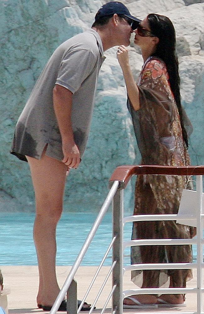 Media mogul James Packer kisses his wife singer Erica Baxter after a swim a...