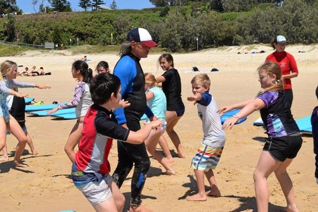 OCEANS OF FUN: Dean Marshall and Rainbow Beach Learn to Surf owner Sarah Booth gave lessons to the visitors. Picture: Arthur Gorrie