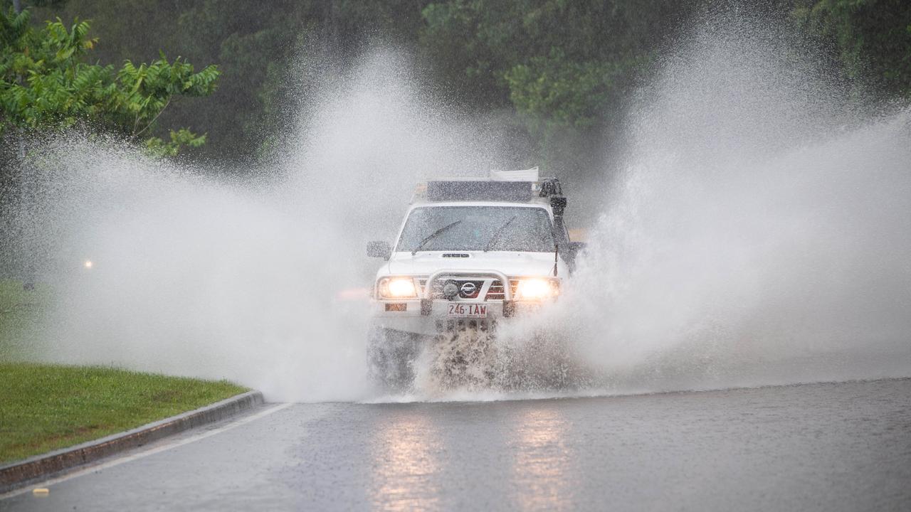 Cars navigate flooded areas along Karawtha Drive, Buderim on the Sunshine Coast. Picture: Brad Fleet