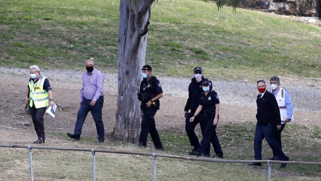 Police and other officials at Indooroopilly State High School on Friday after it was closed due to a Covid-19 case. Picture: Josh Woning